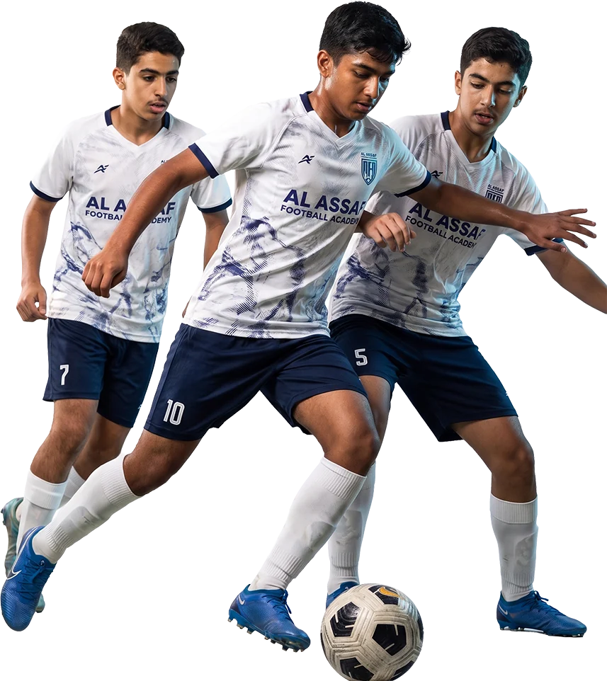 Al Assaf Football Academy players in academy kit competing for the ball